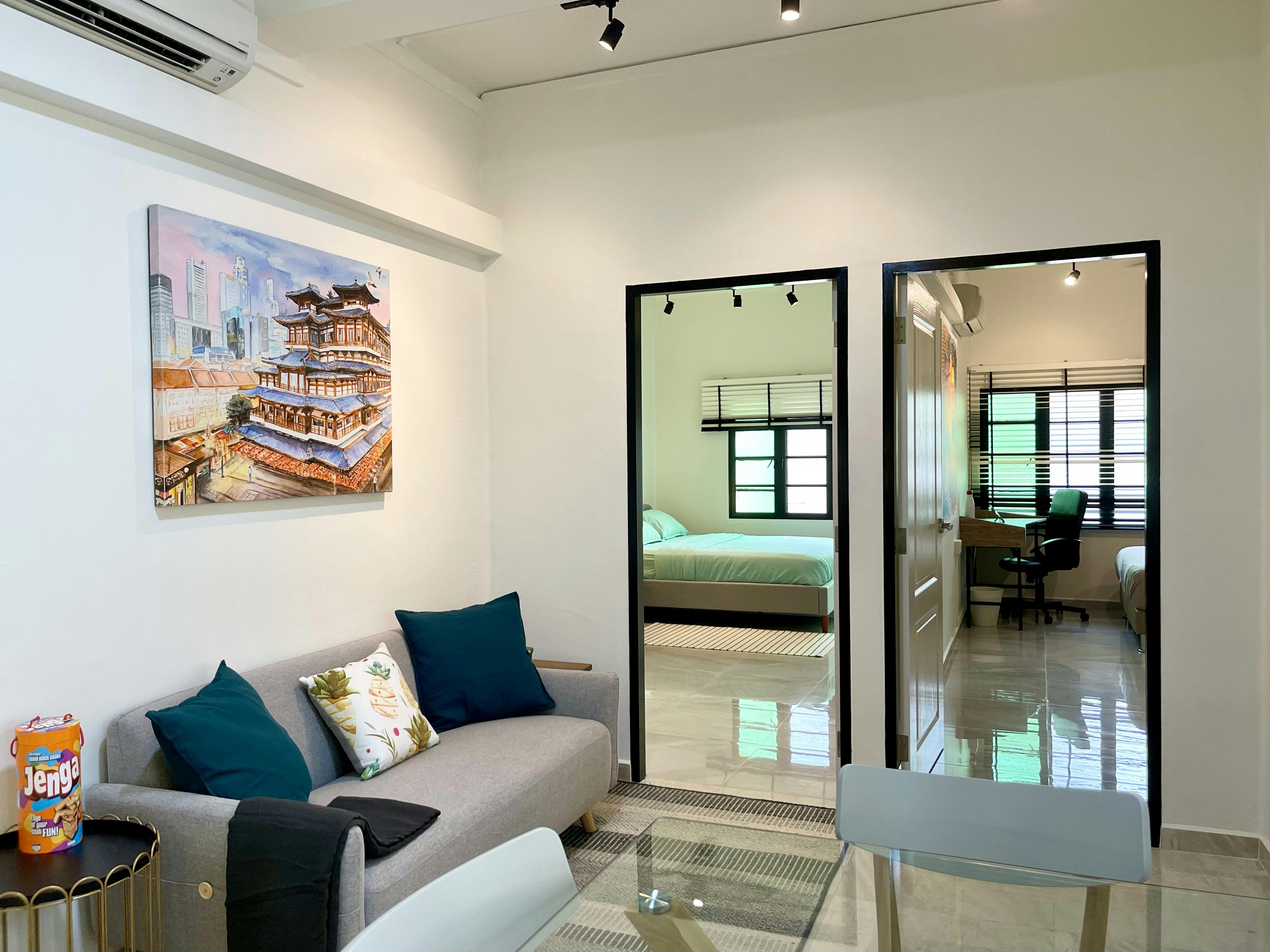 The living room at Casa Mia Tiong Bahru, with "Buddha Tooth Relict Temple Singapore" by Kanchan Mehendale on the walls.