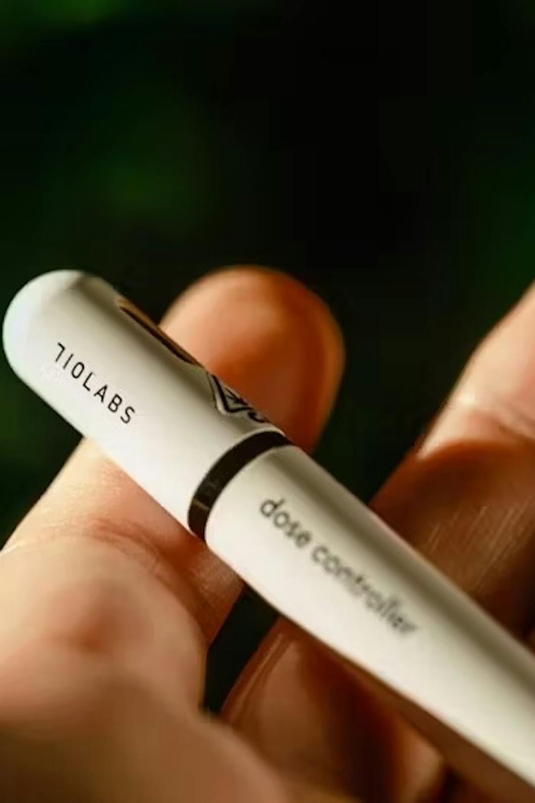 A hand holding a 710 labs dose controller