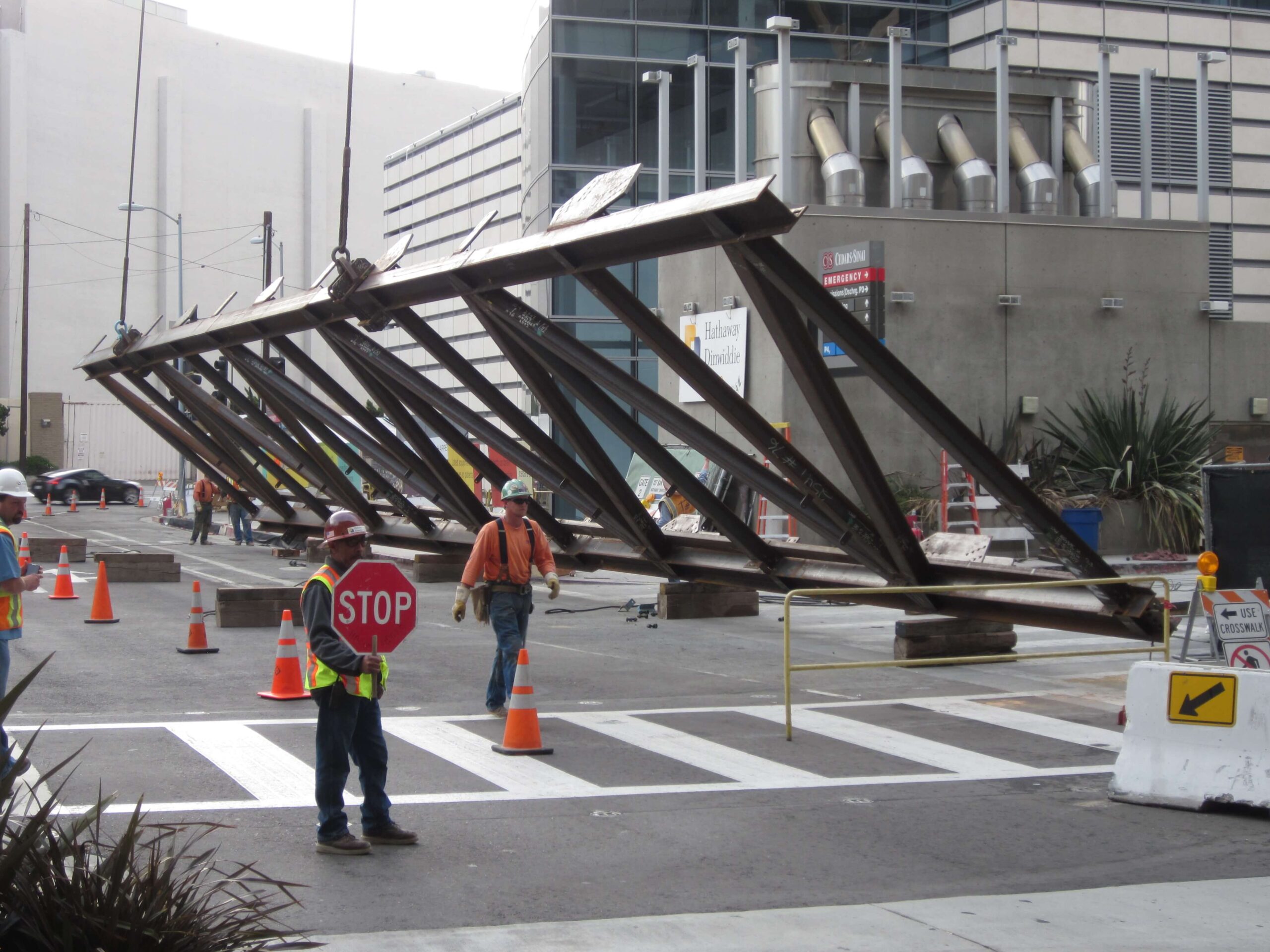 Workers installing large galvanized steel components in California, demonstrating why galvanizing by Coatinc US is essential for durable, corrosion-resistant load-bearing structures.