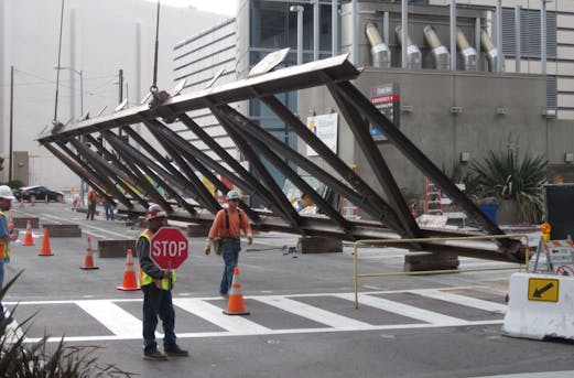 Workers installing large galvanized steel components in California, demonstrating why galvanizing by Coatinc US is essential for durable, corrosion-resistant load-bearing structures.
