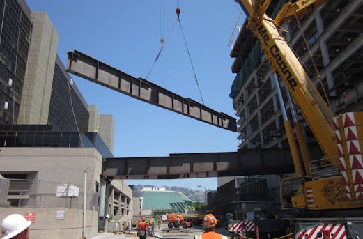Large steel components being installed as part of a load-bearing structure in California, showcasing galvanizing expertise by Coatinc US.