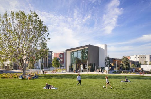 Modern residential areas with apartment buildings and single-family homes featuring galvanized steel elements, showcasing durable corrosion protection by Coatinc US.
