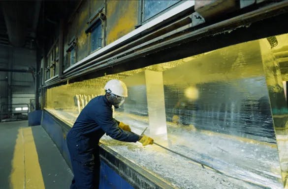 Worker handling steel components during galvanizing operations in California, highlighting expert galvanizing services by Coatinc US.