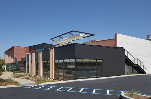 Large building with a prominent galvanized exterior staircase, demonstrating beam galvanizing by Coatinc US for long-lasting durability and corrosion protection.