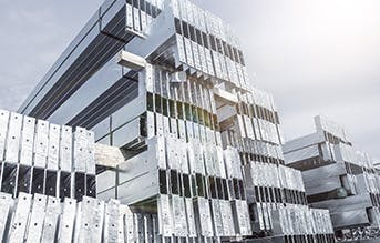 Stack of steel beams treated with beam galvanizing, showing a durable, corrosion-resistant zinc coating for long-term protection. By Coatinc US.
