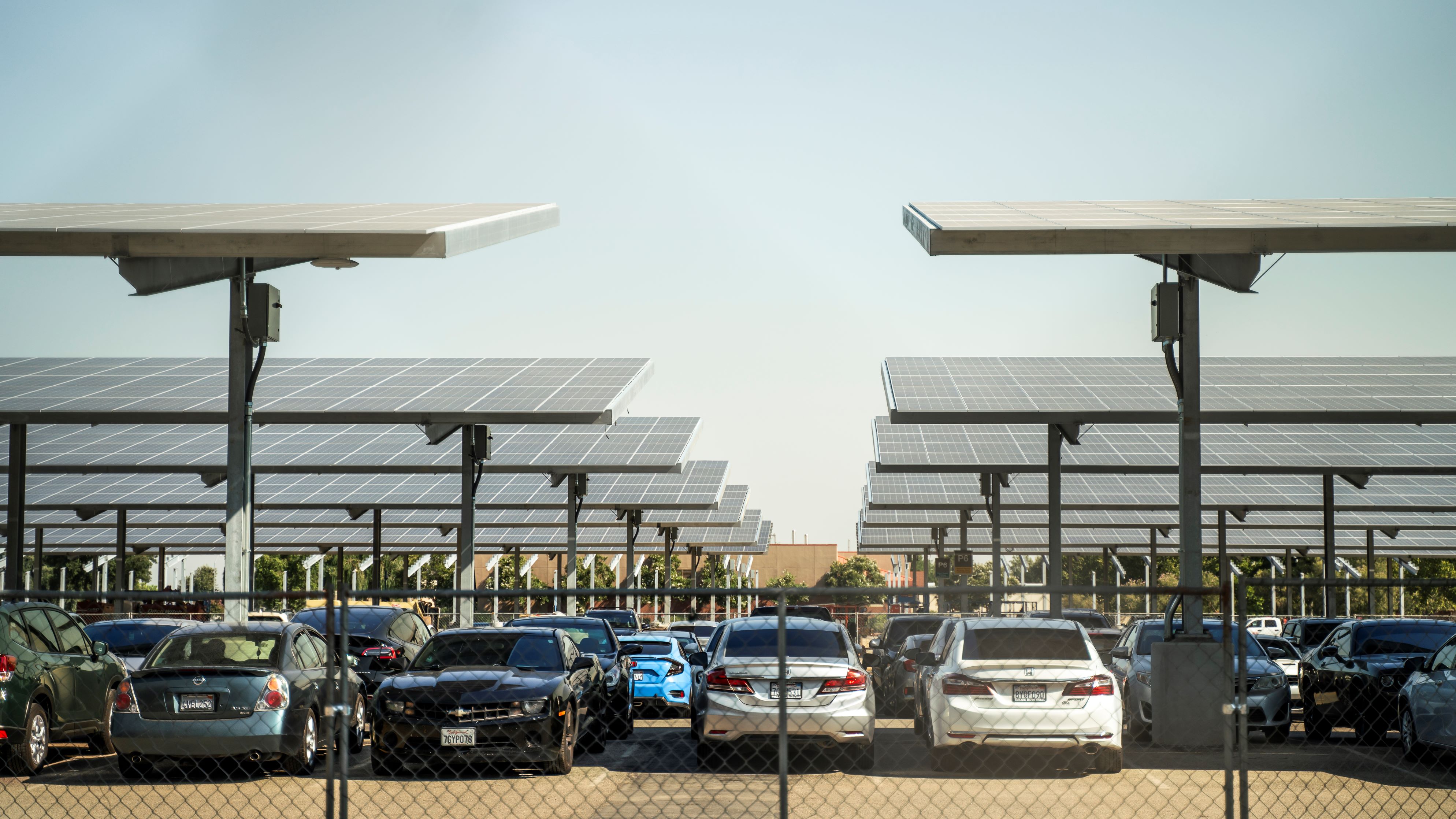 Solar carport canopy supported by galvanized steel structure, showcasing durable corrosion protection by Coatinc US.