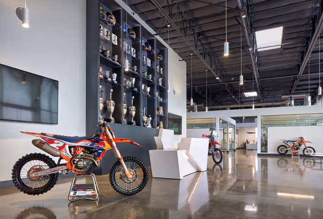 Motorcycle inside a large hall with galvanized room elements and roof structure, demonstrating durable steel protection through galvanizing by Coatinc US.
