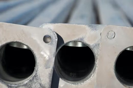 Applications of galvanized steel poles in transportation, telecommunications, and utility networks, showcasing pole galvanizing by Coatinc US for strength, durability, and corrosion resistance.