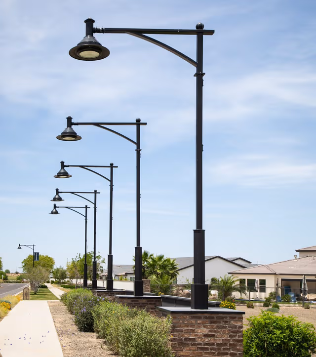 Galvanized street lighting poles undergoing quality inspection at Coatinc US, demonstrating strict quality assurance for durable, corrosion-resistant steel infrastructure.
