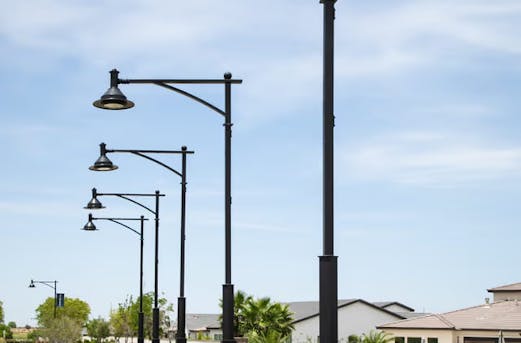 Galvanized street lighting poles undergoing quality inspection at Coatinc US, demonstrating strict quality assurance for durable, corrosion-resistant steel infrastructure.
