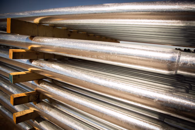Stack of galvanized steel pipes, representing the future of pole galvanizing by Coatinc US with durable, scalable, and sustainable corrosion protection solutions.