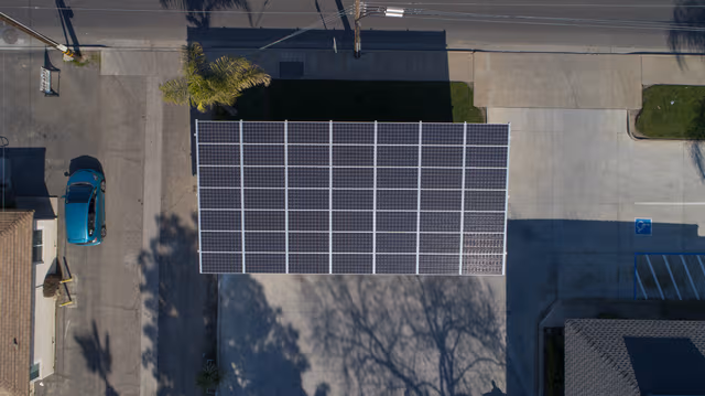 Large solar carport with photovoltaic panels mounted on a galvanized steel structure, providing durable corrosion protection by Coatinc US.