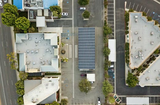 Large solar carport with photovoltaic panels on the roof, showcasing the future of solar carports supported by galvanized steel structures from Coatinc US.