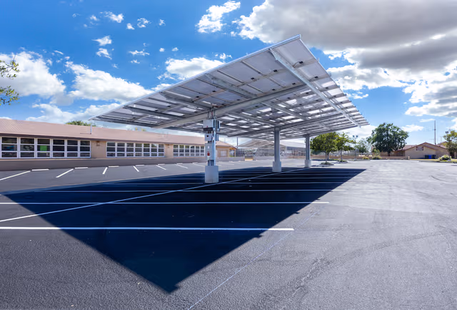Large company parking facility with carports and solar installations, supported by galvanized steel structures and protected by Coatinc US.