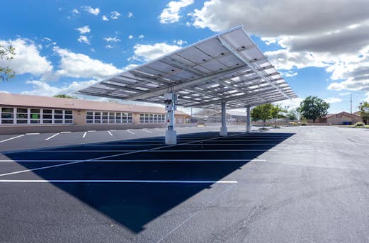 Large company parking facility with carports and solar installations, supported by galvanized steel structures and protected by Coatinc US.