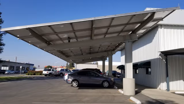 Corporate parking area featuring solar-equipped carports, built with galvanized steel structures for durable protection by Coatinc US.