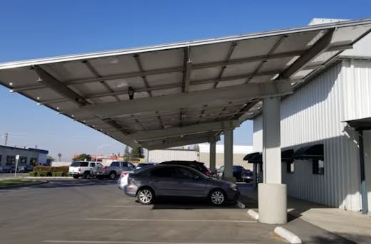 Corporate parking area featuring solar-equipped carports, built with galvanized steel structures for durable protection by Coatinc US.