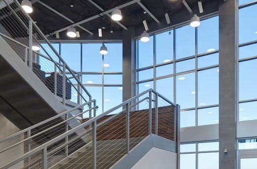 Company entrance hall featuring a steel staircase protected with hot-dip galvanizing, showcasing durable corrosion resistance by Coatinc US.