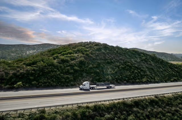 Truck tractor hauling a galvanized steel trailer on the highway, showcasing durable corrosion protection through trailer galvanizing by Coatinc US.