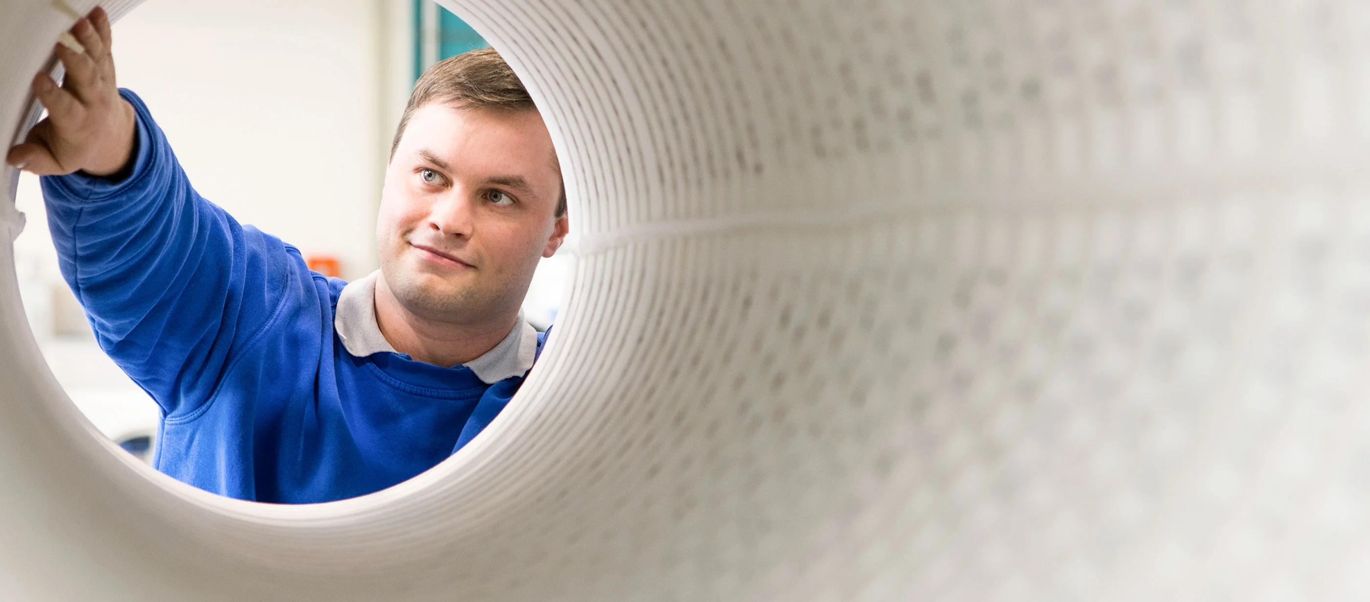 centrotherm employee in front of a quartz tube