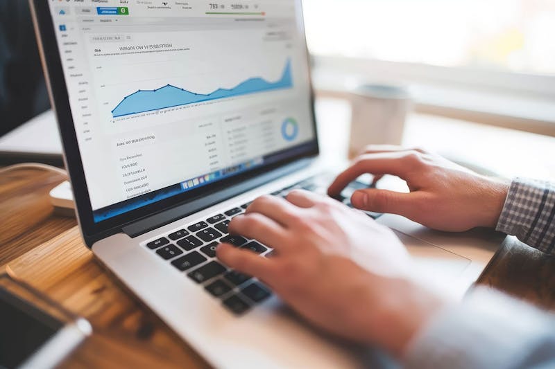 Close up of a laptop screen showing increases in website traffic represented as a graph
