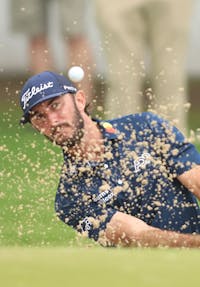 Golfer shooting from Sand