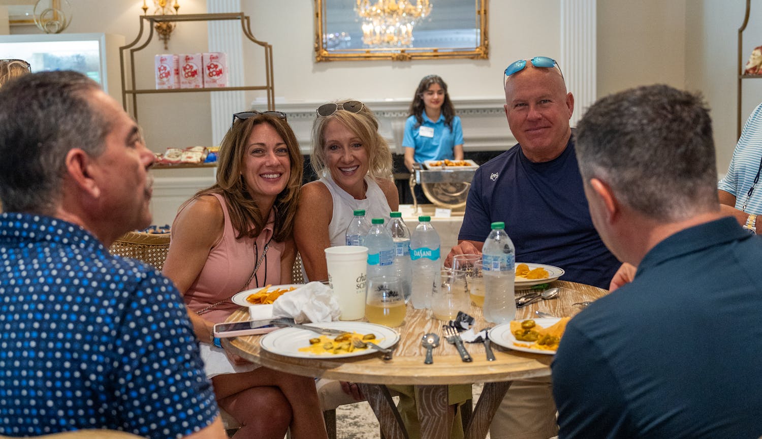 Fans visiting at table eating