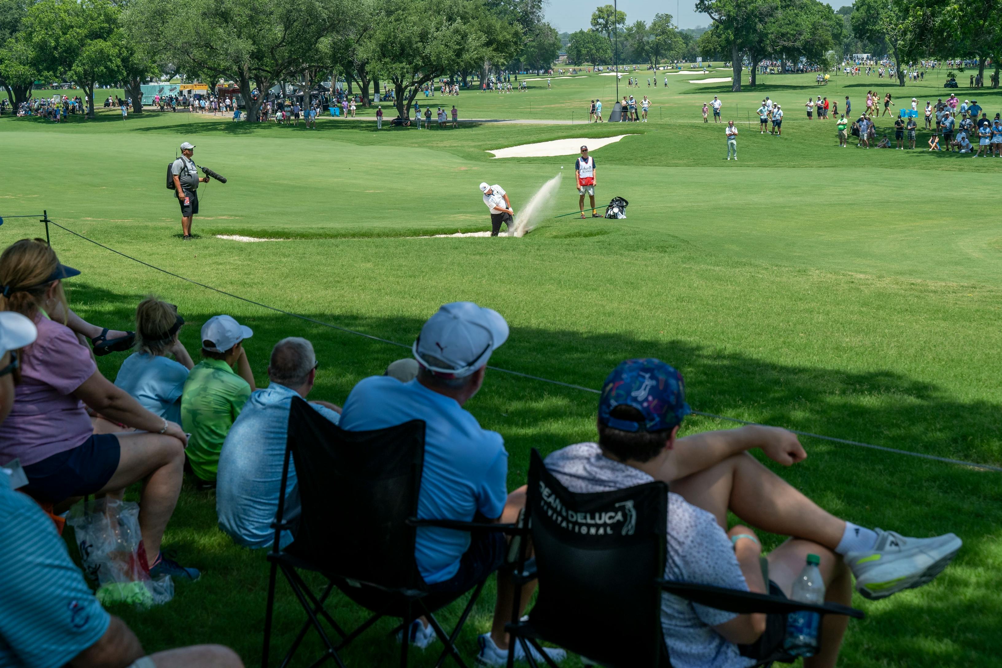 Fans watching from shade
