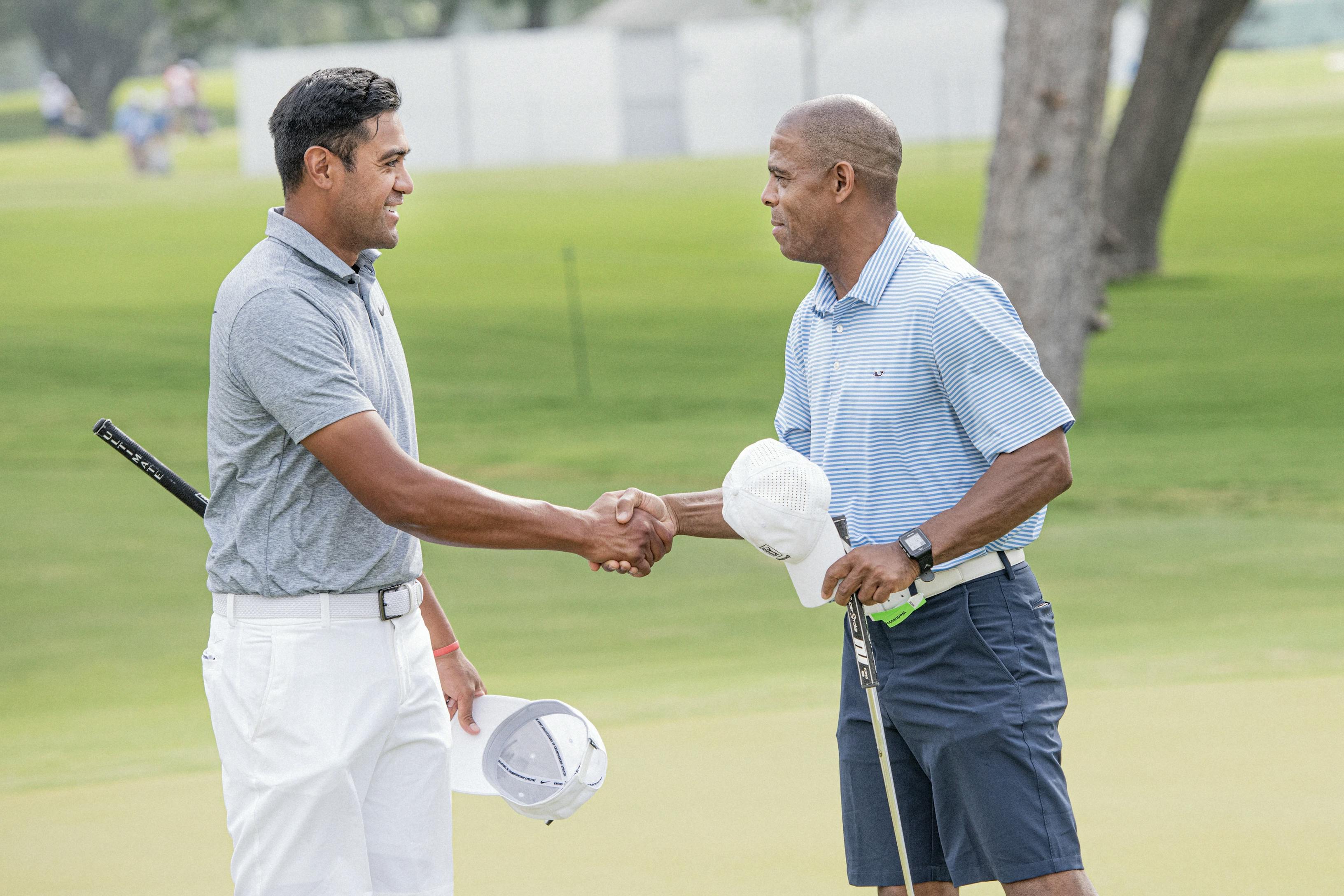 two golfers shaking hands