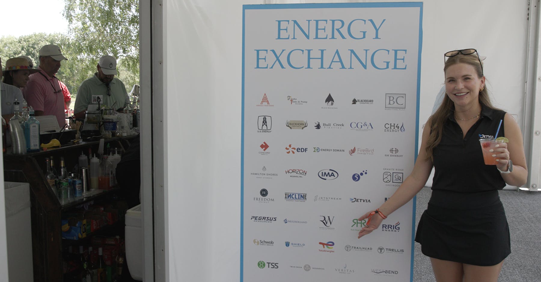 2026 Energy Exchange Woman in front of sign
