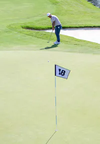 Golfer putting on 18