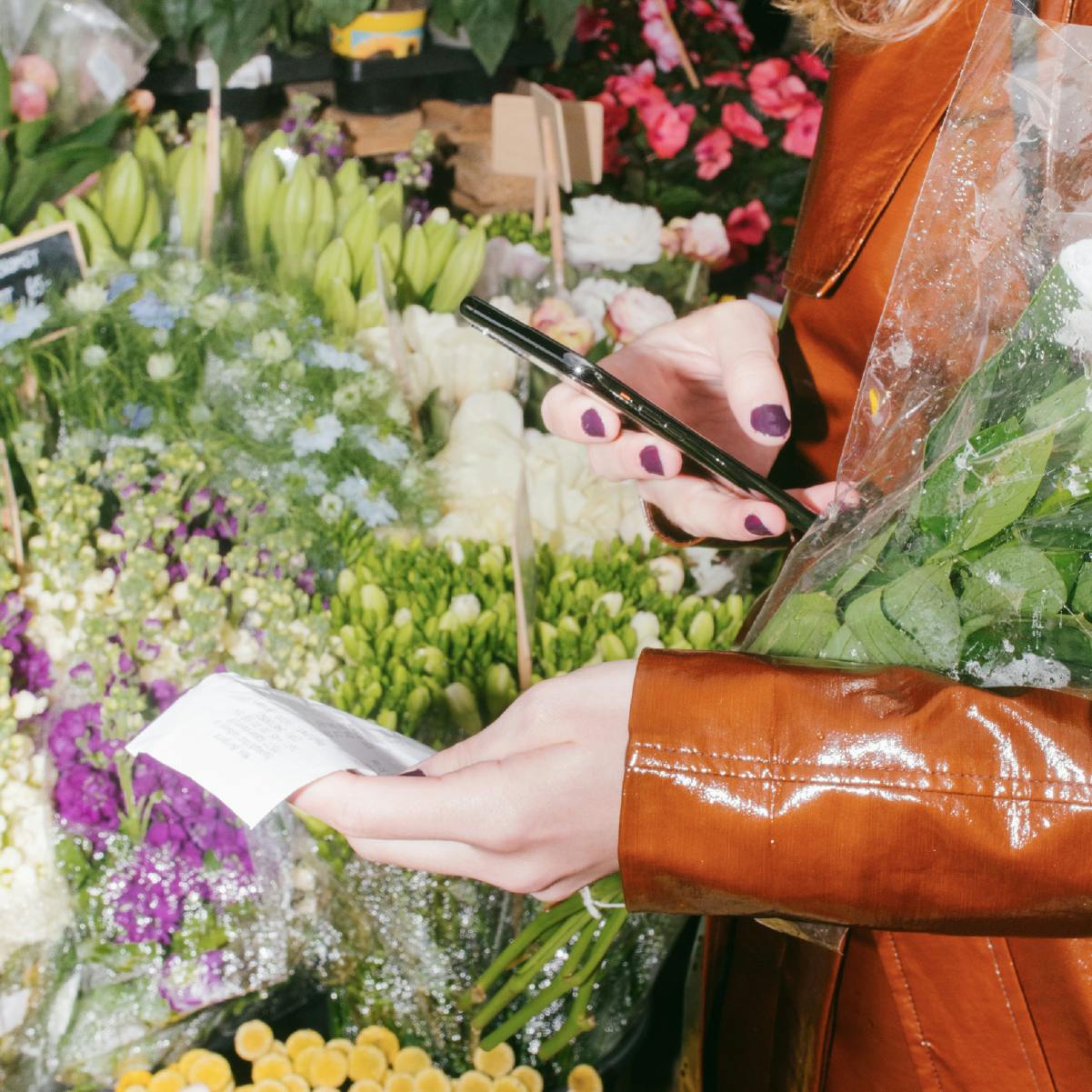 Woman uses Pleo's receipt scanning app to record her expenses