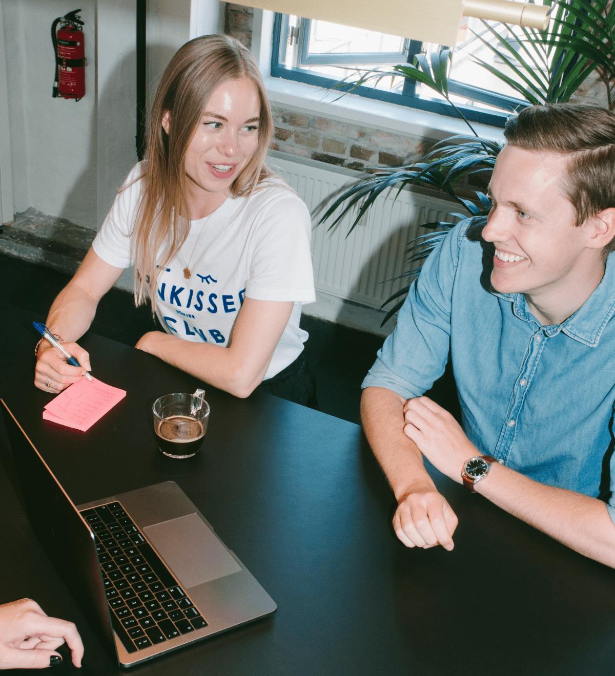 Two people sat at a desk together