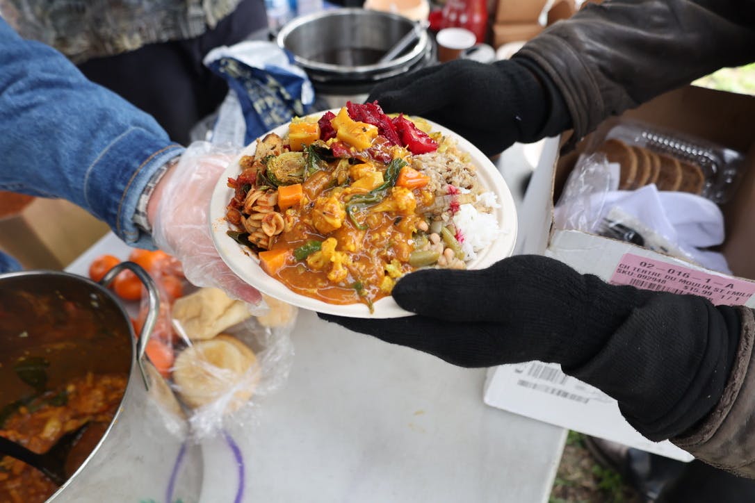 Someone passing a plate of food.