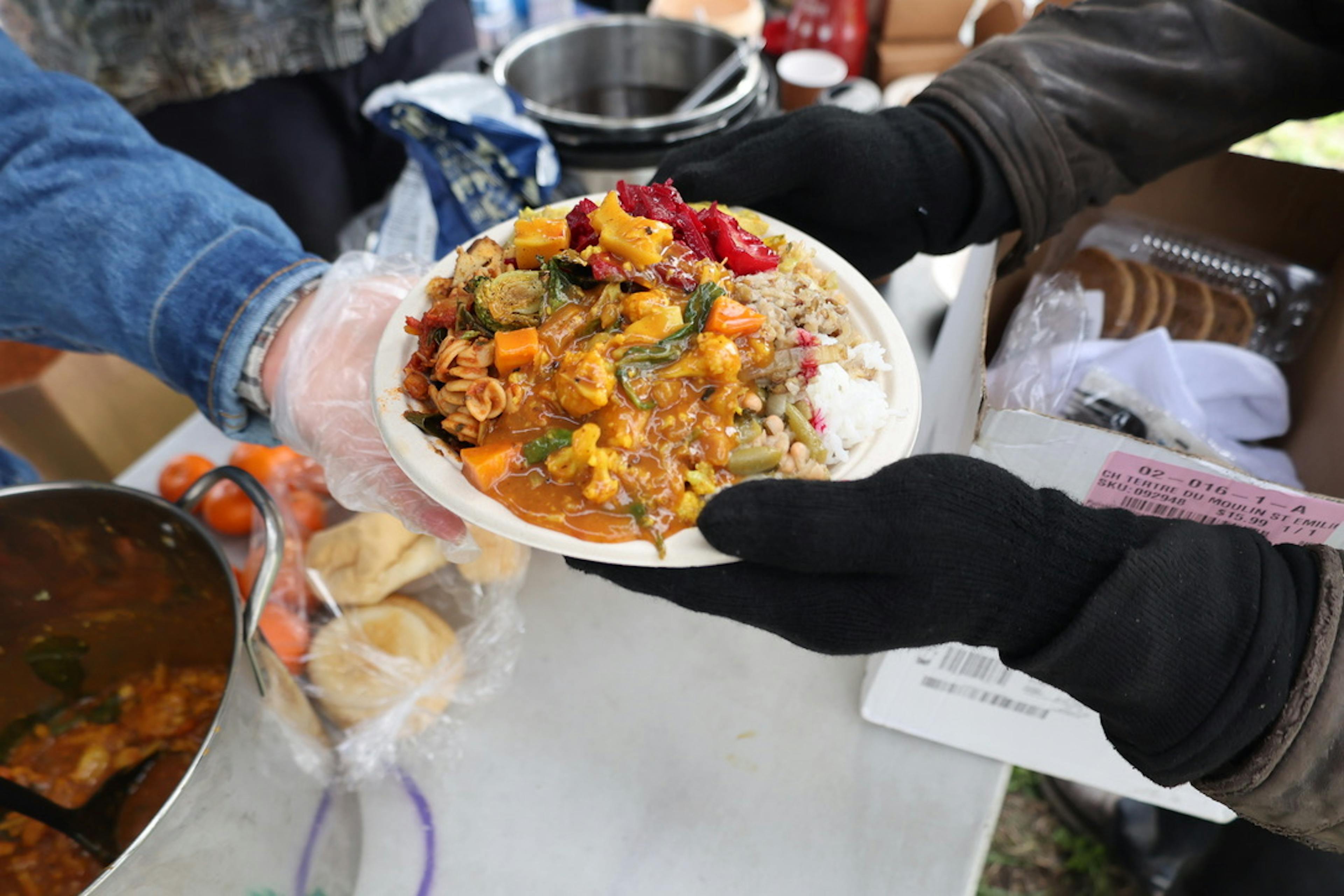 Someone passing a plate of food.