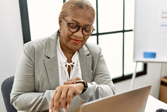 Businesswoman checks her watch