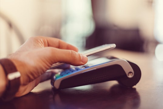 A customer makes a payment using a third-party app on his cell phone.