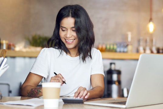 Woman uses accounting software to manage the finances of her small business