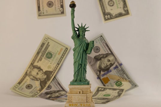 Statue of Liberty with cash raining down