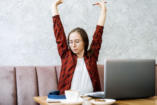 Entrepreneur relaxes as she looks over her work.