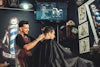 A barber gives a client a haircut
