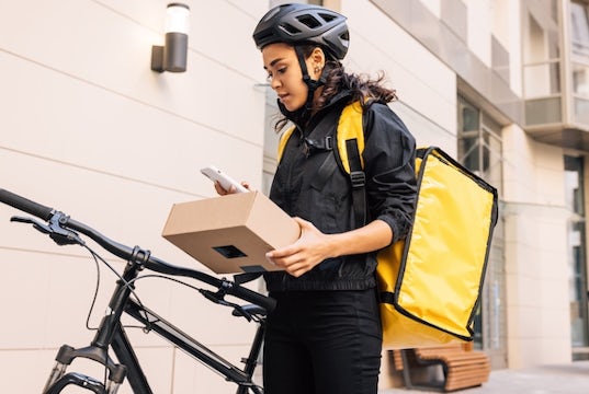 A woman makes a delivery on her bicycle