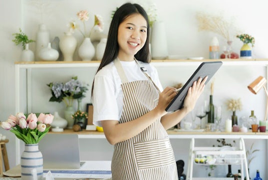 Small business owner reviews inventory in her shop
