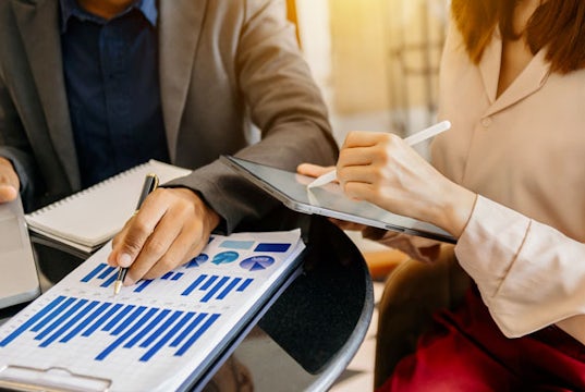 Coworkers review data trends