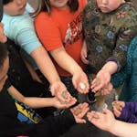 A group of students show off their soapstone carvings