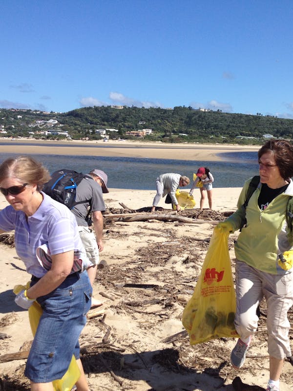 Group of mature students cleaning up a beach