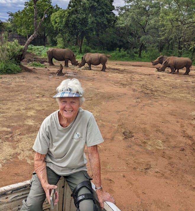 Frances Watson: posing with rhinos in the background