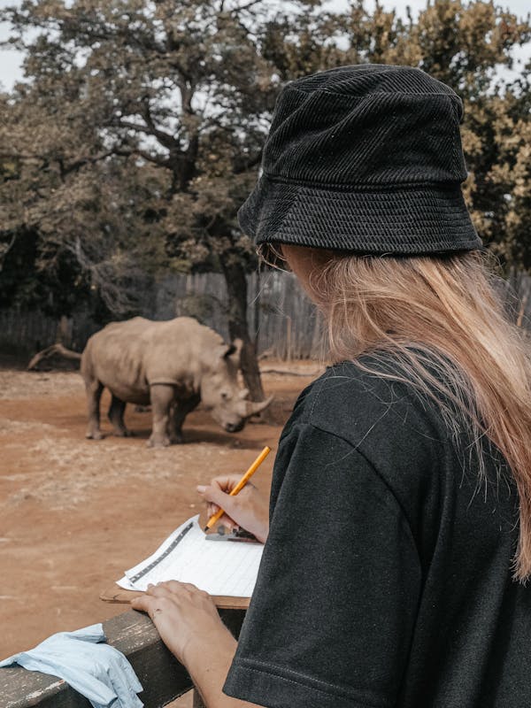 ACE volunteer making notes about a rhino calf, monitoring at The Rhino Orphanage