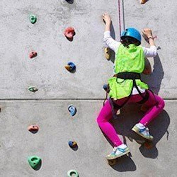 A child on a climbing wall