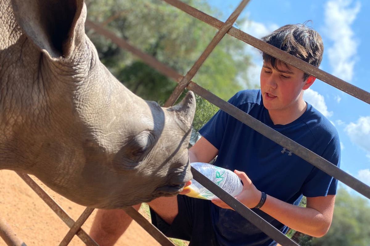 Sam Thain: bottle feeding a rhino
